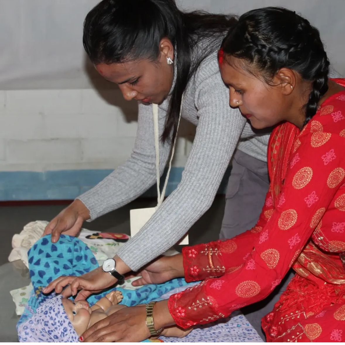 A new mother practising newborn care with an ASN organiser